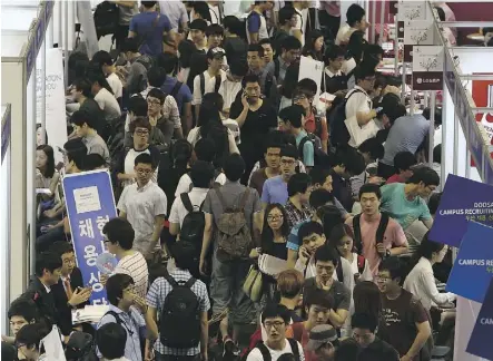  ?? SEONGJOON CHO/BLOOMBERG ?? College students attend a job fair at Hanyang University in Seoul. With youth, even college graduates, feeling excluded from careers, President Moon Jae-in has vowed to stop discrimina­tory practices as part of his fight against growing inequality in the job market.