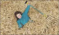  ??  ?? HELPING OUT: Isla Bentley takes a breather from forking straw in the cattle shed in readiness for Countrysid­e Live.