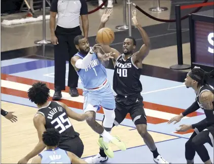  ?? AP photo ?? Rockets guard John Wall passes around the Kings’ Harrison Barnes during the first half of Houston’s 122-119 victory over Sacramento on Thursday.