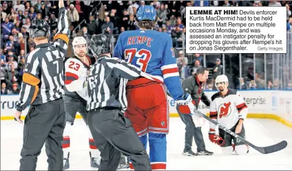  ?? Getty Images ?? LEMME AT HIM! Devils enforcer Kurtis MacDermid had to be held back from Matt Rempe on multiple occasions Monday, and was assessed an instigator penalty for dropping his gloves after Rempe’s hit on Jonas Siegenthal­er.