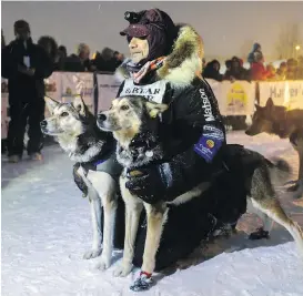  ?? ROBIN WOOD, AP ?? Allen Moore with his lead dogs, Dutch and Commando, after finishing the Yukon Quest dogsled race in Whitehorse, Alaska, on Tuesday.