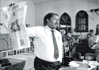  ?? Review-journal file ?? State Sen. Joe Neal holds up a newspaper story about the Clark County district attorney’s decision to not press charges in the 1990 chokehold death of former University of Nevada, Reno basketball star Charles Bush by Las Vegas police officers.