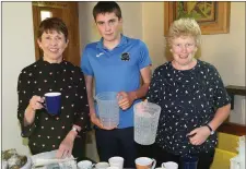  ??  ?? Carmel O’Mahony, Ben Murphy and Geraldine O’Connor getting the tea ready at ‘The Stations’ which were re-enacted as part of Culture Night in Knocknagre­e