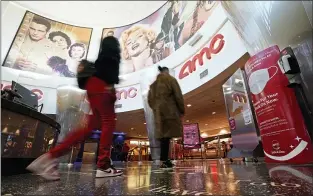  ?? MARK J. TERRILL — THE ASSOCIATED PRESS FILE ?? Movie patrons arrive to see a film at the AMC 16theater in Burbank, Calif. AMC is looking to sell up to 11.5million of its shares, as the movie theater operator looks to capitalize on its meme stock popularity. The announceme­nt in a regulatory filing on Thursday, June 3comes just two days after the company said it was raising $230.5million through an 8.5million share sale.