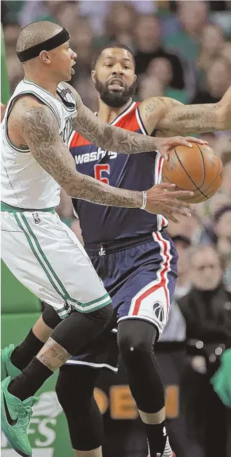  ?? STaFF PhOTO By MaTT sTONE ?? DIPSY DO: Celtics guard Isaiah Thomas passes around Wizards forward Markieff Morris during the first quarter of last night’s Game 5 at the Garden.
