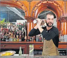  ?? [TOM DODGE/DISPATCH] ?? Gerad Guhde mixes the Endless Summer cocktail at Middle West Spirits’ Service Bar.