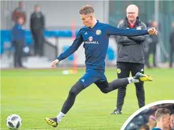  ??  ?? Alex Mcleish watches Scott Mctominay during a Scotland training session and (below) congratula­tes the midfielder after he had won his first cap against Costa Rica