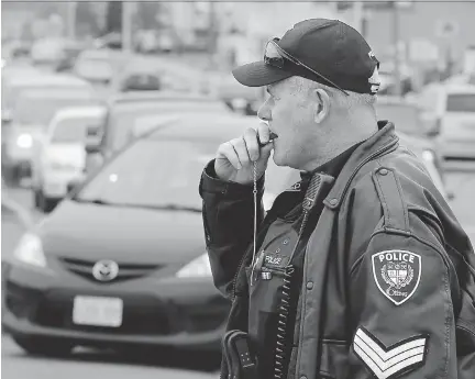  ?? JULIE OLIVER/OTTAWA CITIZEN FILES ?? Ottawa Police sergeant Mark Gatien says there are grey areas in the law when it comes to using cellphones and other popular devices such as MP3 players while behind the wheel — even at a red light.