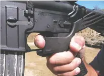  ?? ASSOCIATED PRESS FILE PHOTO ?? Shooting instructor Frankie McRae demonstrat­es the grip on an AR-15 rifle fitted with a bump stock at his 37 PSR Gun Club in Bunnlevel, N.C.