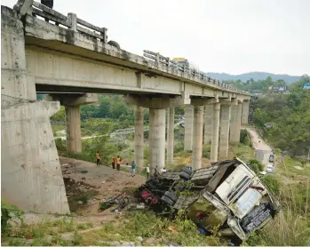  ?? CHANNI ANAND/AP ?? A rescue team inspects the wreckage of a bus Tuesday after it skidded off a bridge in Indian-controlled Kashmir, killing at least 10 and injuring 55, according to police. The bus was carrying Hindu pilgrims to a shrine in the Himalayan region. India has one of the highest road death rates in the world, with hundreds of thousands of people killed and injured annually.