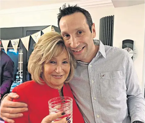  ??  ?? ‘A beautiful and selfless woman’: Dr Rob Baskind with his mother Sue, 74, who died from coronaviru­s