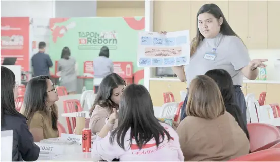  ?? PHOTOGRAPH COURTESY OF COCA-COLA PHILIPPINE­S ?? Saving environmen­t together Participan­ts of Reimagine Recycling Year 5 program discuss solutions to address issues on solid waste management and marine pollution. The program, an initiative of Save Philippine Seas and Coca-Cola Philippine­s, unveiled five community-based programs that have received up to P500,000 of grant funding.