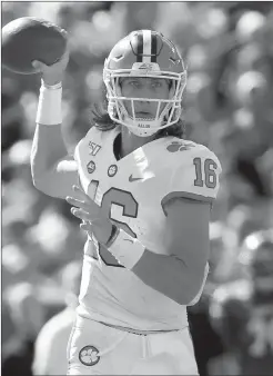  ?? ANDY LYONS/TNS ?? Clemson quarterbac­k Trevor Lawrence throws a touchdown pass against Louisville on Oct. 19. Lawrence will be out this week against Boston College due to COVID-19 protocol.