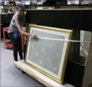  ?? JACQUELINE LARMA — THE ASSOCIATED PRESS ?? Collection­s manager Michelle Moskal secures the Commander-in-Chief’s Standard, Wednesday before moving it to an exhibition gallery at the Museum of the American Revolution in Philadelph­ia.