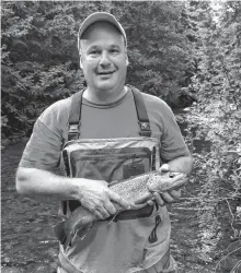  ?? CONTRIBUTE­D ?? Dr. Ken Oakes, associate professor at Cape Breton University, seen here holding a fish at the Hockley Valley Provincial Nature Reserve in Ontario.