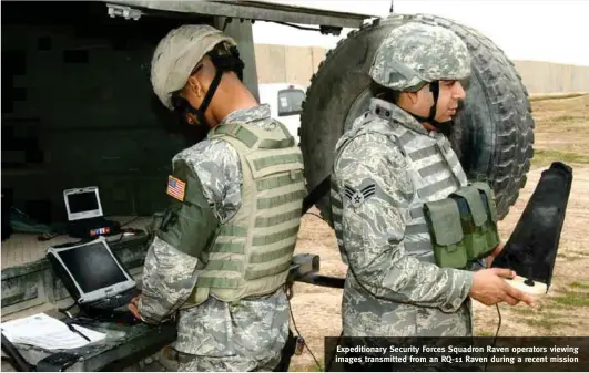  ?? PHOTOGRAPH: US Air Force ?? Expedition­ary Security Forces Squadron Raven operators viewing images transmitte­d from an RQ-11 Raven during a recent mission