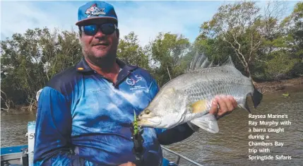  ??  ?? Raysea Marine's Ray Murphy with a barra caught during a Chambers Bay trip with Springtide Safaris