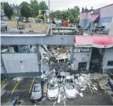  ?? JASON PAYNE, VANCOUVER SUN ?? Emergency services were called to a collapsed parking garage roof at a business on East Broadway near Rupert Street in Vancouver on Thursday.