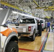  ?? ASSOCIATED PRESS FILE PHOTO ?? United Auto Workers assemblyme­n work on 2018Ford F-150 trucks being assembled at the Ford Rouge assembly plant in Dearborn in this 2018 photo.