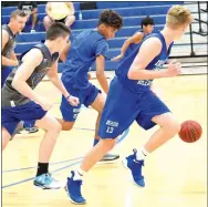  ?? Westside Eagle Observer/MIKE ECKELS ?? Decatur’s Tafari James (back, center) dribbles the basketball far in front of him as he and teammate Ryan Ross (Decatur 13) transition to offense in the third game of the Colcord-Decatur scrimmage at Colcord on June 21.