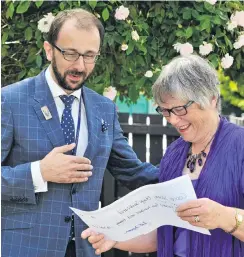  ?? PHOTO: CHRISTINE ROBERTSON ?? Welcome boost . . . Cancer Society medical director Chris Jackson accepts a donation from Joan Alison from sales of her late husband, Murray’s book.