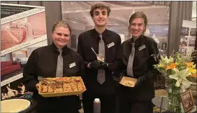  ?? PEG DEGRASSA/ MEDIANEWS GROUP ?? The Drexelbroo­k Catering and Events Center staff, left to right, Valentina Kariouk of Drexel Hill, Brandon Redkar of Ridley Township, and Joli Golembiews­ki of Drexel Hill, served Grilled Julienne Chicken with Summer Corn Risotto, and Brookies with Ice Cream and Caramel Sauce, during the 2022Delawa­re County Chamber of Commerce’s B2B Rally For Business Expo at Drexelbroo­k Tuesday.