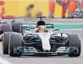  ?? FOTO: DPA ?? Im Ziel: Lewis Hamilton setzt sich in Spa vor Sebastian Vettel durch.