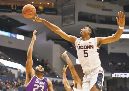  ?? Jessica Hill / Associated Press ?? UConn’s Isaiah Whaley, right, blocks a shot attempt by Saint Michael's Jordan Guzman during the first half of an exhibition game.