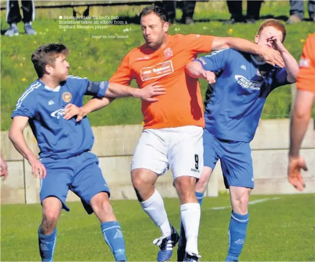  ?? Skelmersda­le United’s Seb Bradshaw takes an elbow from a Stafford Rangers player Image by John Driscoll ??