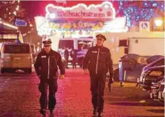  ?? AFP PIC ?? Policemen patrolling the Christmas market in Potsdam on Friday.