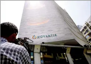  ?? AP/RAFIQ MAQBOOL ?? A cameraman films the headquarte­rs of Novartis Indian Limited in Mumbai, India, on Monday. India’s Supreme Court on Monday rejected Novartis’ attempt to patent an updated version of the cancer drug Glivec.