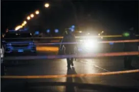  ?? ARMANDO L. SANCHEZ — CHICAGO TRIBUNE VIA AP ?? Police work the scene where a 11-year-old was shot on the 10300 block of South Avenue N Wednesday in Chicago.