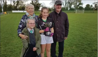  ??  ?? Ciara Dwyer An Gaelscoil Tomas Daibhis who won the North Cork Primary Schools Final pictured with her sister Aoife and Grandparen­ts Liam and Mary.