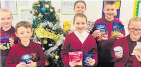  ??  ?? Parklee Community School pupils with donations for their local foodbank