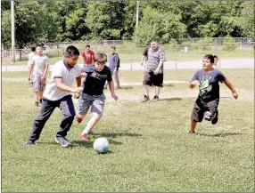  ?? RACHEL DICKERSON/MCDONALD COUNTY PRESS ?? A group of boys plays soccer during recess at Noel Elementary School. Summer school goes through June 29 and involves many fun activities.