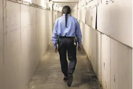  ??  ?? Sonny Hasme walks down the undergroun­d tunnel that leads to individual toll booths at the Carquinez Bridge toll plaza in Vallejo. Hasme was an exuberant toll collector for 19 years.