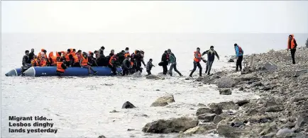  ??  ?? Migrant tide... Lesbos dinghy lands yesterday