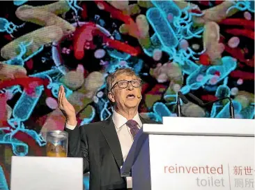  ?? AP ?? Bill Gates, former Microsoft CEO and co-founder of the Bill and Melinda Gates Foundation, speaks as a jar of human faeces sits on a podium at the Reinvented Toilet Expo in Beijing yesterday.