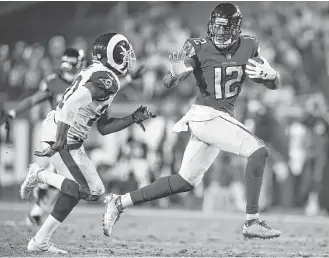  ?? Kelvin Kuo / Associated Press ?? Falcons wide receiver Mohamed Sanu, who caught four passes for 75 yards, is ready to take on Rams defender Lamarcus Joyner, left, in the second half of Saturday night’s NFC wild-card game.