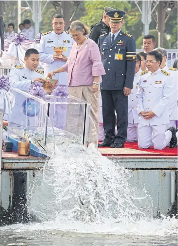  ?? PHOTO: THITI WANNAMONTH­A ?? MAKING A SPLASH: Her Royal Highness Princess Maha Chakri Sirindhorn presides over a fish release ceremony at Wasukree Pier yesterday. The princess released 590,000 fish into the Chao Phraya River as part of her 61st birthday celebratio­ns.