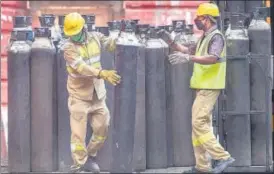  ?? PTI ?? Workers move medical oxygen cylinders to refill in Kolkata on Wednesday.