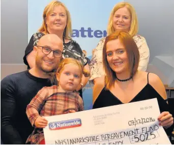  ??  ?? Cheque this Graeme Downie and Laura McKeating plus daughter Anna with from back left Lyn Clyde, head of midwifery and operationa­l manager women’s services, and senior midwife, Wendy Drysdale