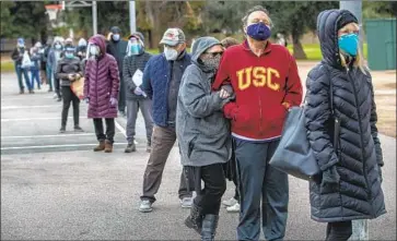  ?? Mel Melcon Los Angeles Times ?? in an hours-long vaccinatio­n line at the Balboa Sports Complex in Encino on Jan. 27.