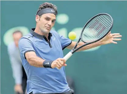  ??  ?? Roger Federer hits a backhand return during his quarter-final match against Florian Mayer in Halle.