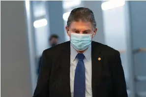  ?? The Associated Press ?? Sen. Joe Manchin, D-W.Va., walks to a vote in the Senate Chamber on Wednesday in Washington.