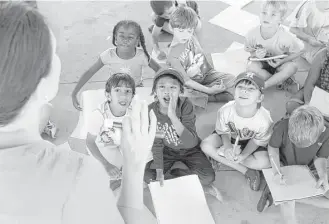  ?? Jon Shapley / Houston Chronicle ?? Students from Lisa Austin’s first-grade class shout answers Friday during a math lesson in a park, where Pope Elementary teachers organized a special school day while their building was flooded.