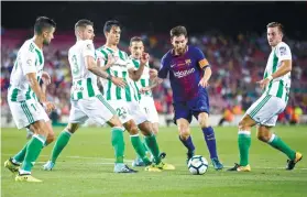  ?? AP FOTO ?? 1 VS. 5. Lionel Messi attracts five defenders in Barcelona’s La Liga debut.