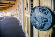  ?? GABRIELA CAMPOS THE NEW MEXICAN ?? The old Camel Rock Casino doors remain shut after it was closed last month. Tesuque Pueblo is considerin­g turning the old casino into an indoor flea market, among other options.