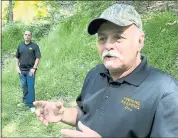  ?? MICHAEL RUBINKAM — THE ASSOCIATED PRESS ?? Dennis Parada, right, and his son Kem Parada stand at the site of the FBI’s dig for Civil War-era gold in Pennsylvan­ia.