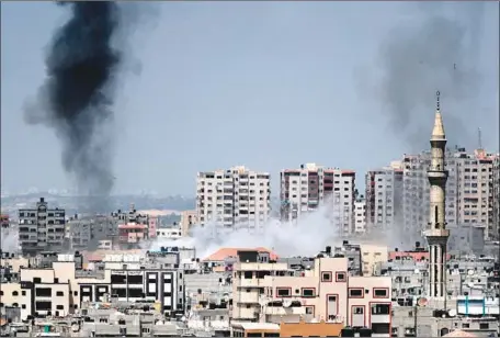  ?? Thomas Coex AFP/Getty Images ?? SMOKE BILLOWS in Gaza City after an Israeli airstrike. The Israeli army said it targeted more than 30 military sites in the Gaza Strip in response to the barrage of rockets and mortar rounds from the enclave. “Terror of any type will be met with great...